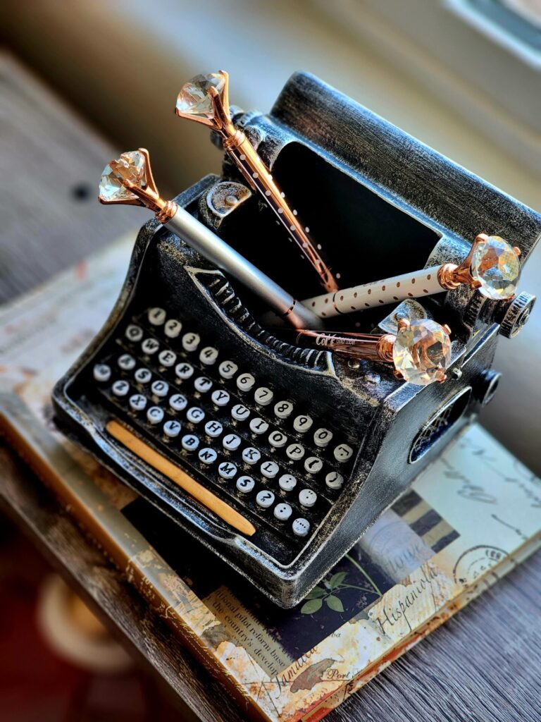 An old fashioned typewriter with fancy pens